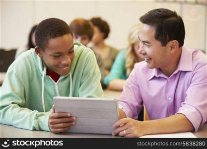 High School Student With Teacher Using Digital Tablet