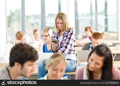 High school student - woman with mp3 player in classroom