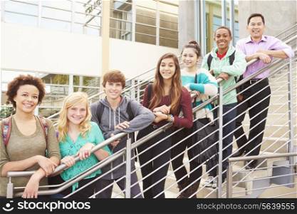 High School Students And Teacher Standing Outside Building