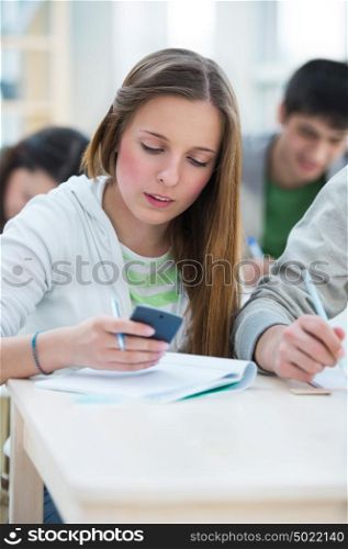 High School students. Beautiful girl calculating numbers in classroom during lesson