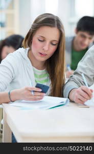 High School students. Beautiful girl calculating numbers in classroom during lesson