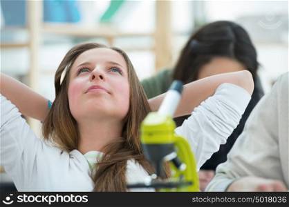 High School students. Beautiful girl relaxing at biology classroom during brake