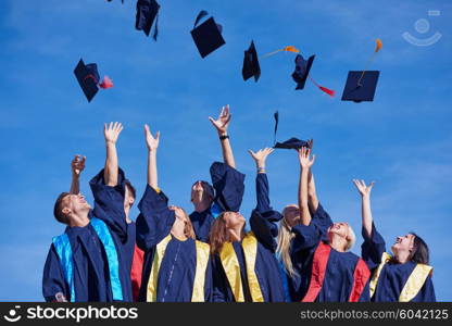 high school students graduates tossing up hats over blue sky.