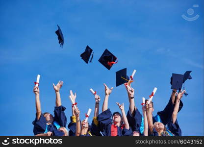 high school students graduates tossing up hats over blue sky.