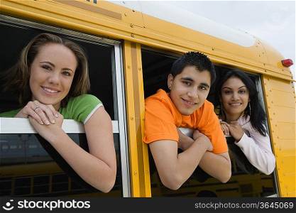 High School Students Looking Out Windows of School bus