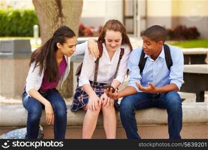High School Students Using Mobile Phone On School Campus