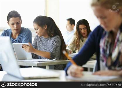 High School Students With Laptops And Digital Tablets