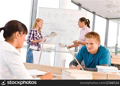 High school students with professor in classroom studying