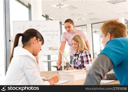 High school students with professor in classroom studying