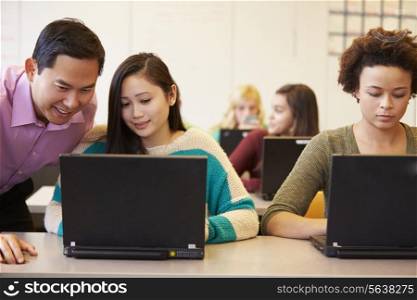 High School Students With Teacher In Class Using Laptops