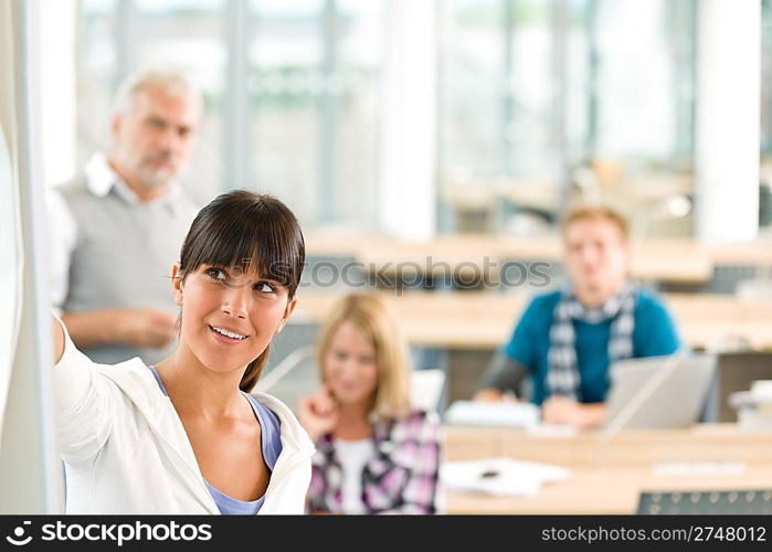 High school - three students with mature professor in classroom