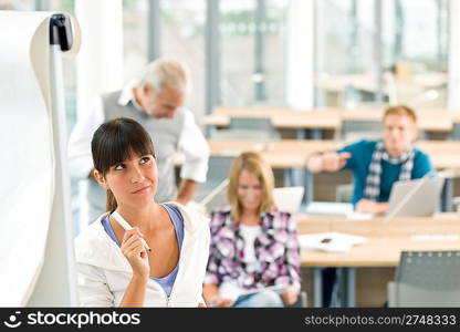 High school - three students with mature professor in classroom