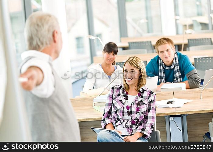 High school - three students with mature professor in classroom