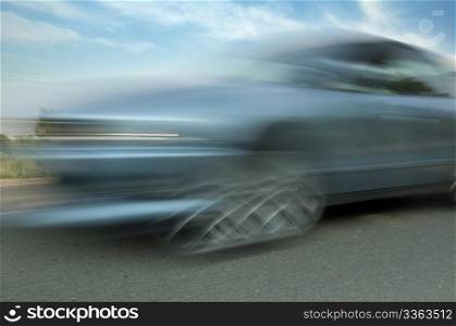 High speed blurred car with blue sky