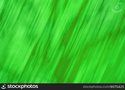 High speed motion blurred green background. Slow shutter speed with motion blur green effect.. Decorative green backdrop fast speedy motion no focus.