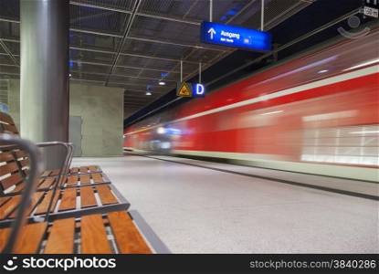high speed red train crossing trainstation in Berlin Germany