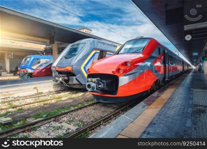 High speed trains on the train station at sunset Venice, Italy. Beautiful modern intercity passenger trains on the railway platform. Railroad in Europe. Railway station. Passenger transportation