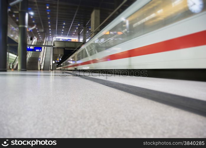 high speed white train crossing trainstation in Berlin Germany