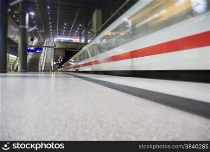 high speed white train crossing trainstation in Berlin Germany