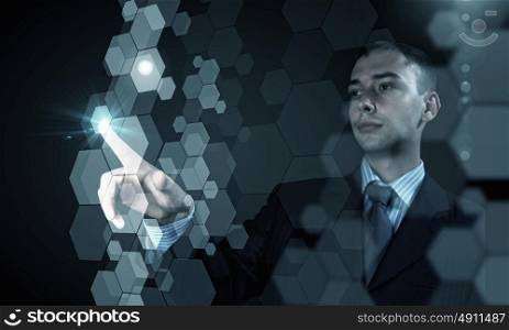 High technologies. Close up of businessman touching digital screen with finger