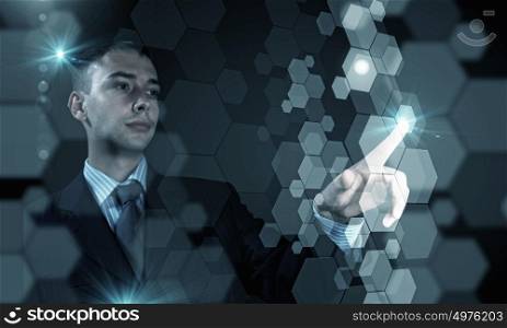 High technologies. Close up of businessman touching digital screen with finger