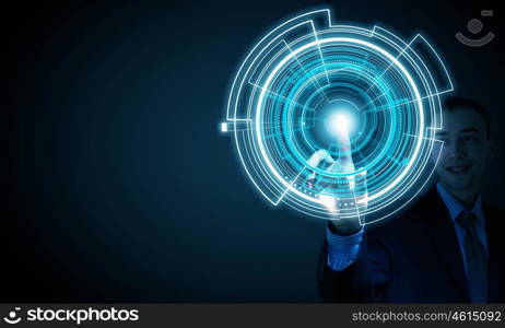 High technologies. Young businessman pressing high tech circle icon on media screen