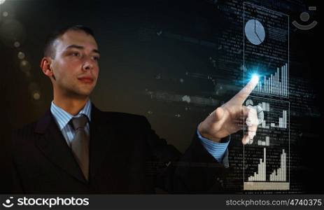 High technologies. Young businessman pressing high tech icon on media screen