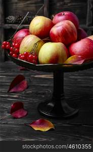 High vase with apples. Harvest of juicy autumn apples in vase for fruits