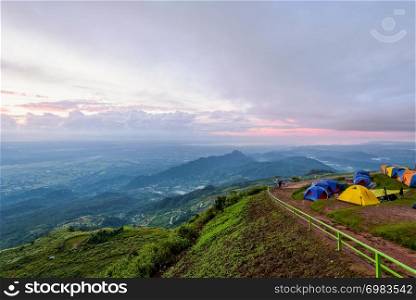 High view beautiful nature landscape of colorful sky during the sunrise from the campsite at Phu Thap Berk viewpoint, famous tourist attractions of Phetchabun Province, Thailand. Phu Thap Berk during the sunrise