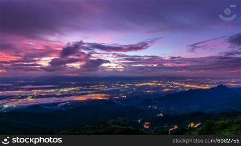 High view beautiful nature landscape of colorful sky during the sunrise see the lights of the road and city at Phu Thap Berk viewpoint, Phetchabun Province, Thailand, 16:9 wide screen. Phu Thap Berk Viewpoint at the sunrise