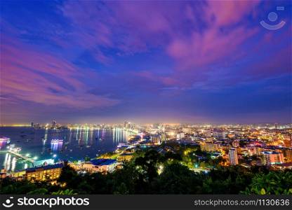 High view on viewpoint see cityscape with colorful light at the beach and the sea of ??Pattaya Bay, beautiful landscape of Pattaya City at night scene landmark in Chonburi, Travel Asia to Thailand. Pattaya City at night scene landmark in Thailand