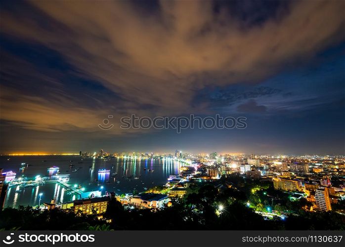 High view on viewpoint see cityscape with colorful light at the beach and the sea of ??Pattaya Bay, beautiful landscape of Pattaya City at night scene landmark in Chonburi, Travel Asia to Thailand. Pattaya City at night scene landmark in Thailand