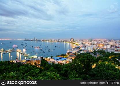 High view on viewpoint see cityscape with colorful light at the beach and the sea of Pattaya Bay, beautiful landscape of Pattaya City at sunset landmark in Chonburi, Travel Asia to Thailand. Pattaya City at sunset landmark in Thailand
