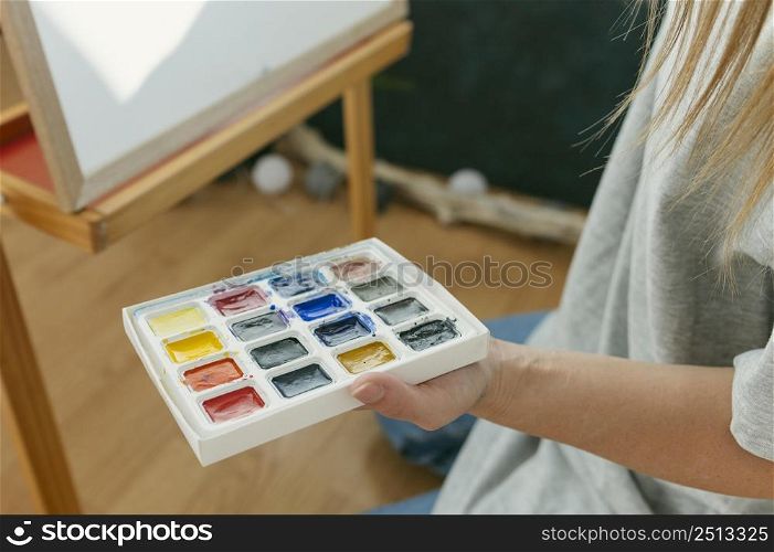 high view painter holding her color palette