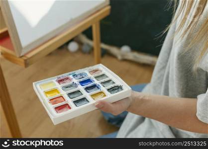 high view painter holding her color palette
