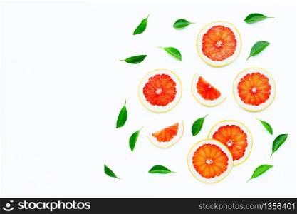 High vitamin C. Juicy grapefruit slices with leaves on white background.