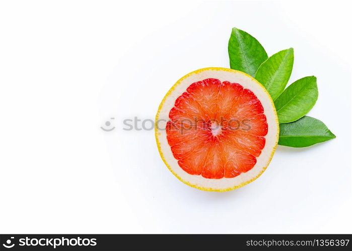 High vitamin C. Juicy grapefruit with leaves on white background. Copy space