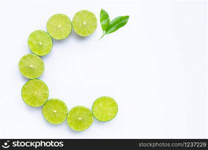 High vitamin C, Letter C made of limes with leaves isolated on white background. Copy space