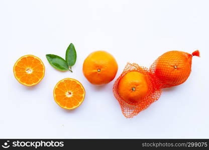 High vitamin C. Orange in net bag with ripe half of orange on white background.