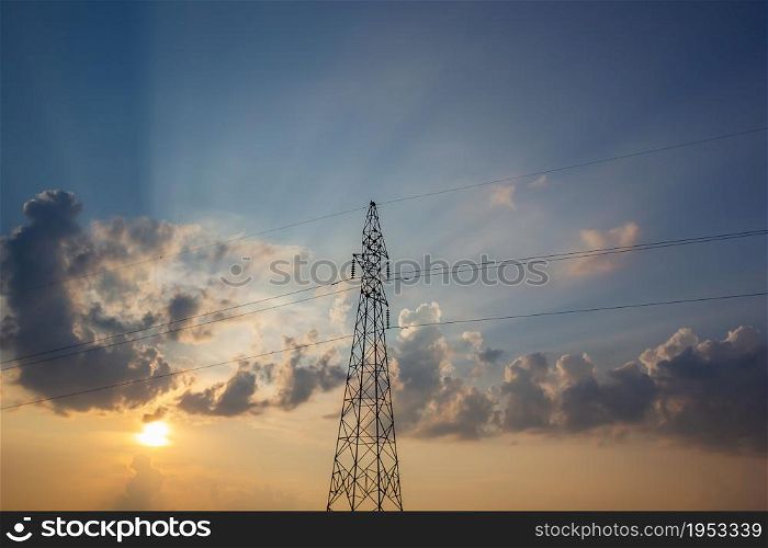 High Voltage Electric Power Lines On Pylons In Sunset.