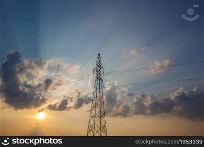 High Voltage Electric Power Lines On Pylons In Sunset.