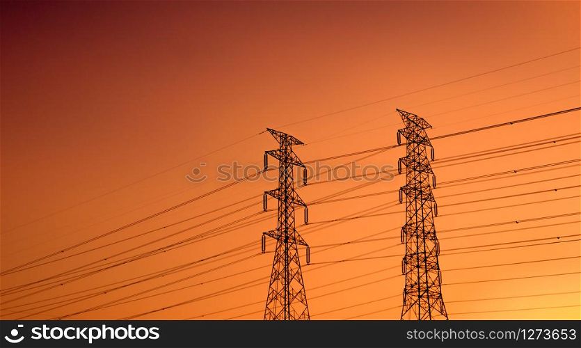 High voltage electric pylon and electrical wire with sunset sky. Electricity poles. Power and energy support factory concept. High voltage grid tower with wire cable. Beautiful red-orange sunset sky.