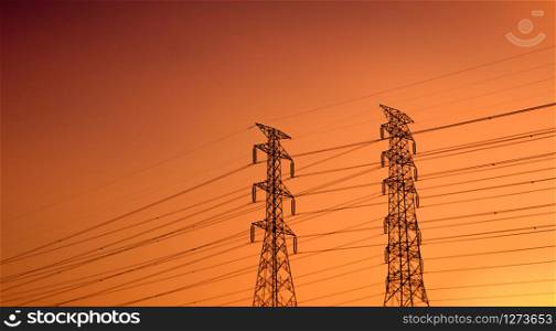 High voltage electric pylon and electrical wire with sunset sky. Electricity poles. Power and energy support factory concept. High voltage grid tower with wire cable. Beautiful red-orange sunset sky.