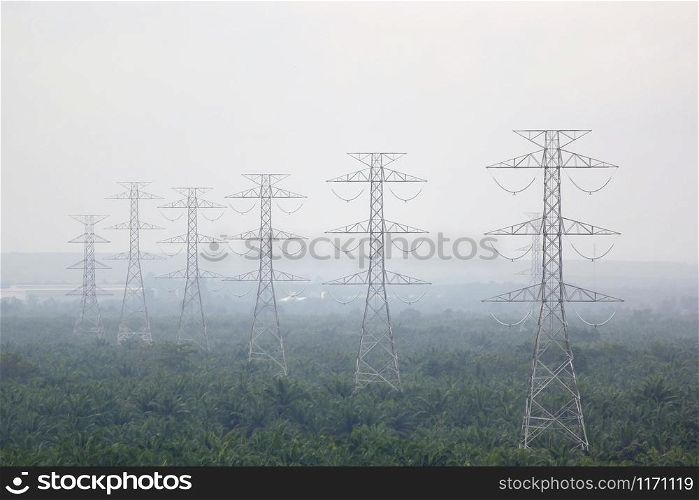 high voltage electric tower in foggy area