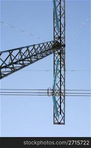 High voltage electricity pylon structures against blue sky
