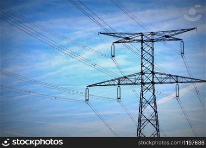 High voltage post. High-voltage tower on blue sky background .. High voltage post. High-voltage tower on blue sky background