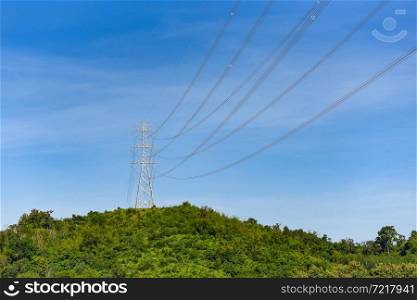 High voltage post, High voltage tower sky background on the mountain forest, Electricity poles and electric power transmission lines against countryside
