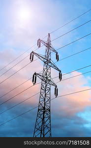 High voltage post or high voltage tower against the evening sky