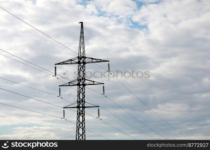 high-voltage power lines on blue sky background. electricity distribution station. Electrical net of poles on a panorama. power tower. high-voltage power lines on blue sky background. electricity distribution station. Electrical net of poles on a panorama. power tower.