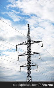 high-voltage power lines on blue sky background. electricity distribution station. Electrical net of poles on a panorama. power tower. high-voltage power lines on blue sky background. electricity distribution station. Electrical net of poles on a panorama. power tower.